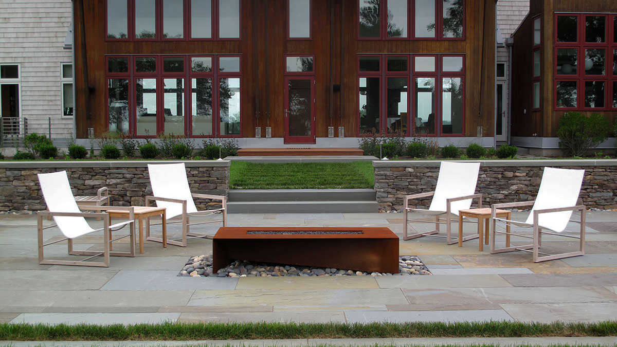 A Corten Steel Fire Pit Brings the Warm Tones of the House Into the Landscape
