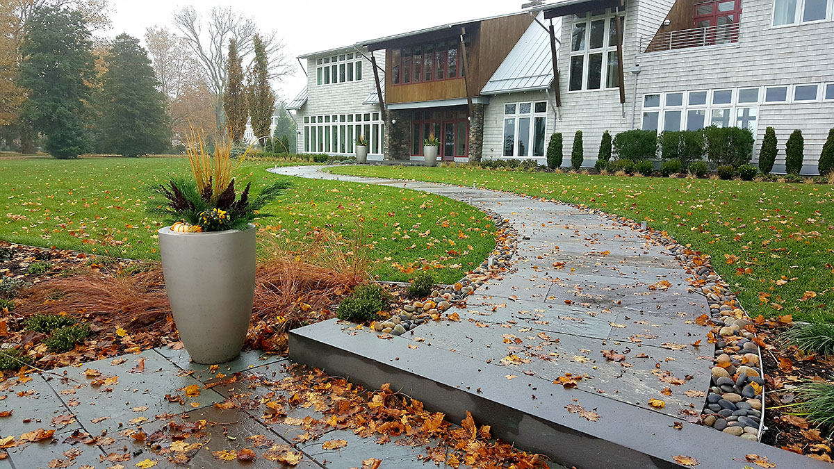 A Curving Bluestone Walkway Breaks Up the Linear Nature of the Front Yard
