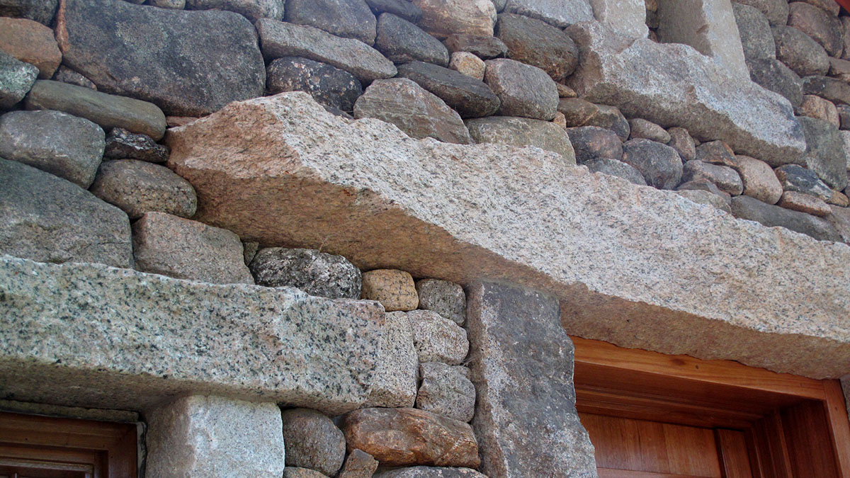 Salvaged Granite is Repeated Throughout the Facade Creating a Rhythm of Stone